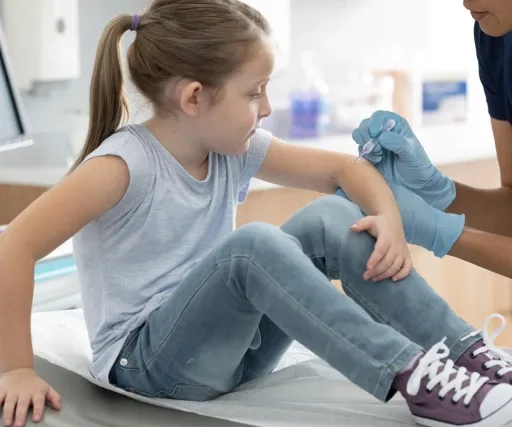 Trained female healthcare provider administering YCANTH® (cantharidin) topical solution, 0.7% in-office to a young female patient